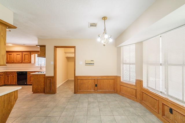 6914 Coral Ridge Rd, Houston, TX 77069 - unfurnished dining area featuring a wainscoted wall, light tile patterned flooring, and a sink