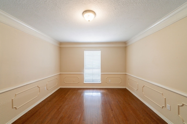 6914 Coral Ridge Rd, Houston, TX 77069 - empty room featuring wood finished floors, a textured ceiling, ornamental molding, and wainscoting