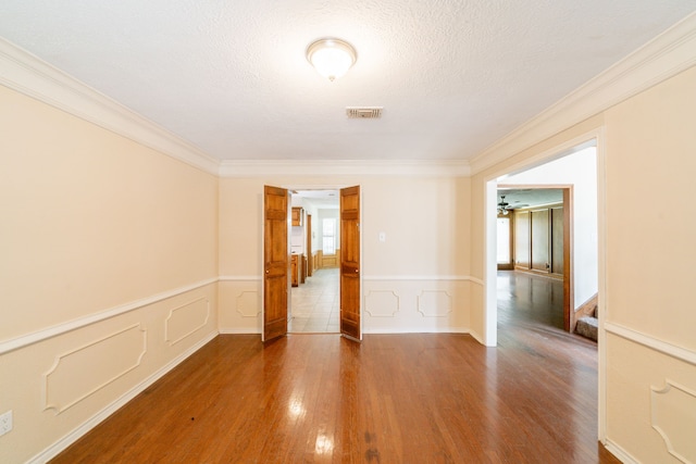 6914 Coral Ridge Rd, Houston, TX 77069 - spare room featuring wood finished floors, ornamental molding, wainscoting, and ceiling fan