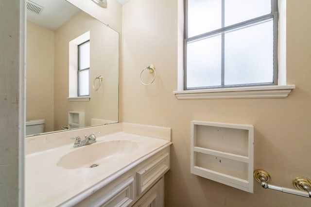 6914 Coral Ridge Rd, Houston, TX 77069 - bathroom with toilet, vanity, and plenty of natural light
