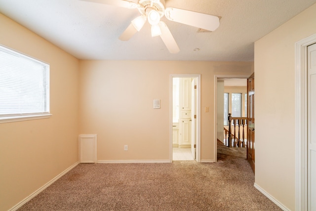 6914 Coral Ridge Rd, Houston, TX 77069 - empty room with light carpet, ceiling fan, and baseboards