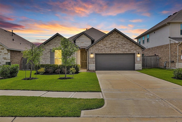 1217 Antelope Passing Dr, Montgomery, TX 77316 - french country inspired facade with a garage, driveway, stone siding, and brick siding