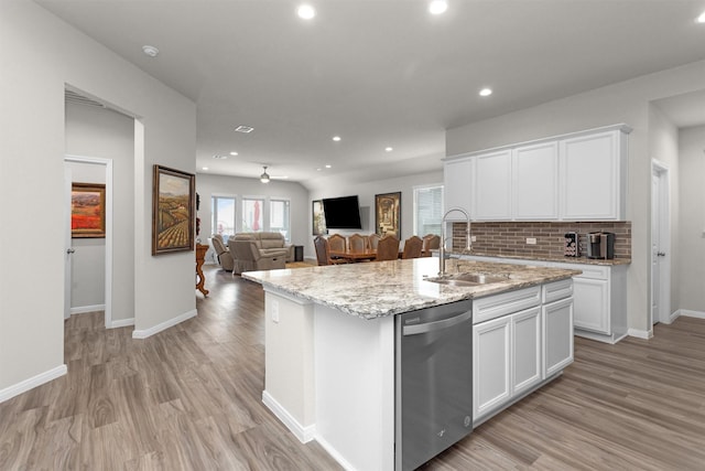 1217 Antelope Passing Dr, Montgomery, TX 77316 - kitchen featuring dishwasher, a sink, recessed lighting, backsplash, and white cabinetry
