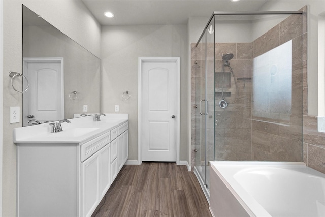 1217 Antelope Passing Dr, Montgomery, TX 77316 - full bath featuring a bath, a shower stall, double vanity, wood finished floors, and recessed lighting