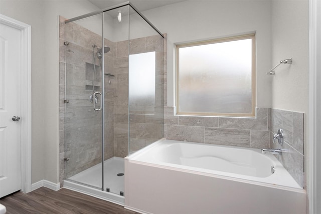 1217 Antelope Passing Dr, Montgomery, TX 77316 - full bath featuring a bath, a stall shower, and wood finished floors
