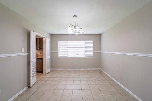 3614 Cheaney Dr, Houston, TX 77066 - unfurnished dining area featuring a chandelier and baseboards