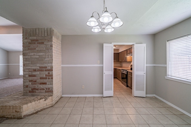 3614 Cheaney Dr, Houston, TX 77066 - unfurnished dining area featuring a chandelier, baseboards, and light tile patterned floors