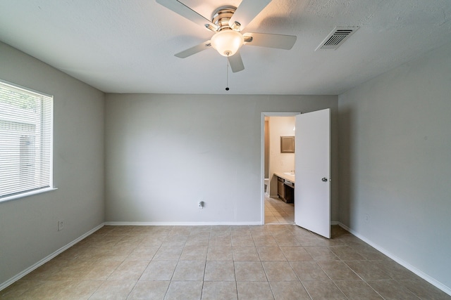 3614 Cheaney Dr, Houston, TX 77066 - empty room with a ceiling fan, light tile patterned floors, and baseboards