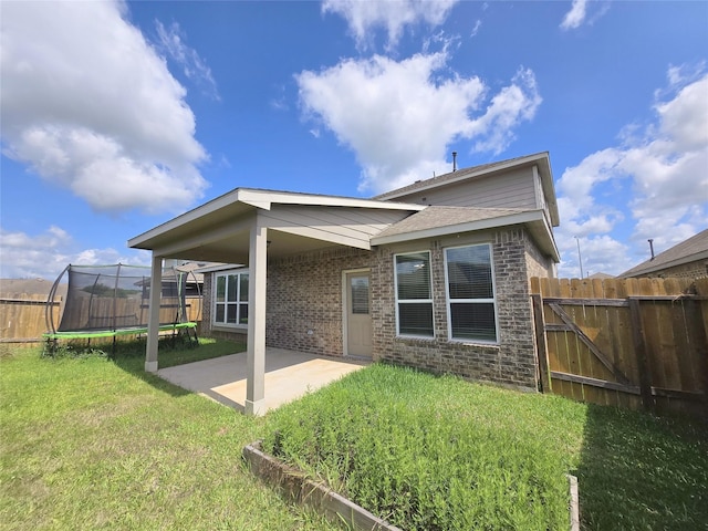 3559 Britton Burrow Way, Richmond, TX 77406 - rear view of house featuring a trampoline, a patio area, and brick siding