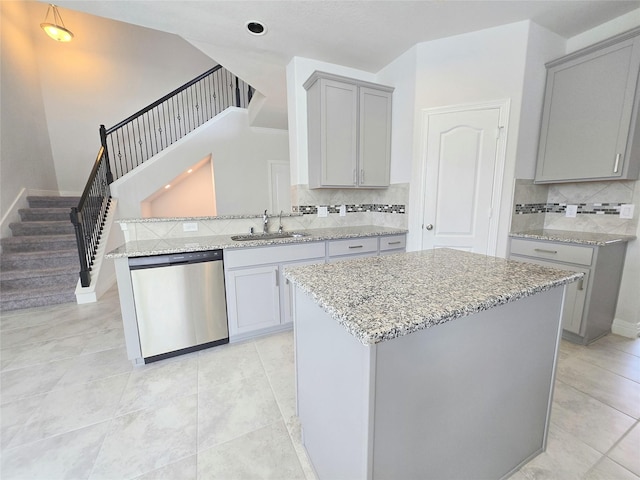 3559 Britton Burrow Way, Richmond, TX 77406 - kitchen featuring dishwasher, gray cabinetry, decorative backsplash, light stone counters, and a sink