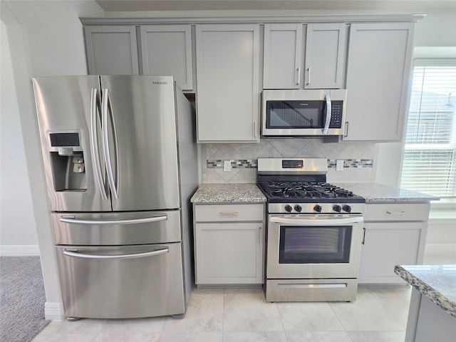3559 Britton Burrow Way, Richmond, TX 77406 - kitchen featuring appliances with stainless steel finishes, gray cabinets, backsplash, and light stone counters