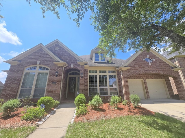 12515 Stoney Creek Dr, Pearland, TX 77584 - view of front of property featuring brick siding, an attached garage, and driveway