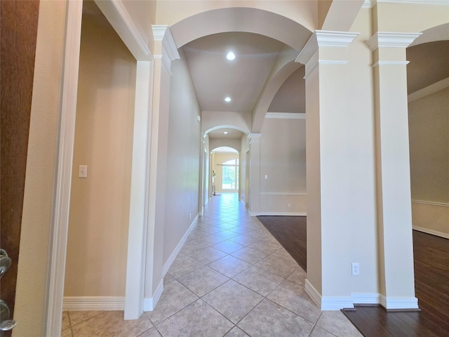 12515 Stoney Creek Dr, Pearland, TX 77584 - hall with arched walkways, ornate columns, light tile patterned flooring, recessed lighting, and baseboards