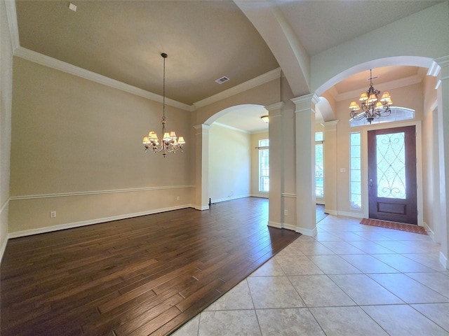 12515 Stoney Creek Dr, Pearland, TX 77584 - entryway with a chandelier, ornate columns, ornamental molding, arched walkways, and wood finished floors