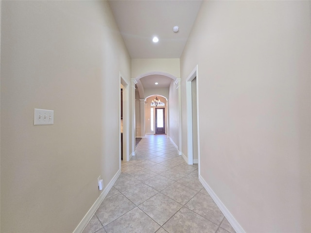 12515 Stoney Creek Dr, Pearland, TX 77584 - hall featuring arched walkways, light tile patterned floors, decorative columns, recessed lighting, and baseboards