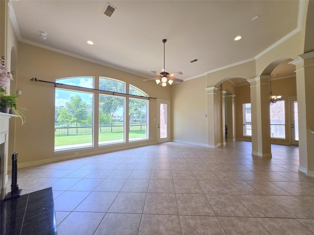 12515 Stoney Creek Dr, Pearland, TX 77584 - unfurnished living room featuring ornate columns, plenty of natural light, a ceiling fan, light tile patterned floors, and ornamental molding