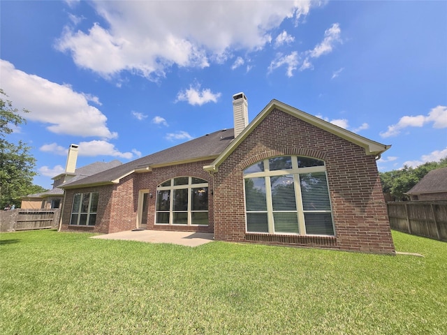 12515 Stoney Creek Dr, Pearland, TX 77584 - rear view of house featuring a chimney, brick siding, and a patio