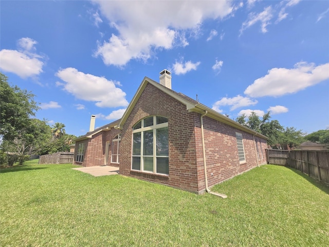 12515 Stoney Creek Dr, Pearland, TX 77584 - rear view of property with a chimney, brick siding, and a patio area