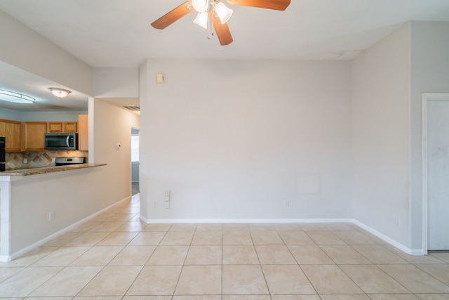 6635 Rusty Ridge Ln, Katy, TX 77449 - spare room with a ceiling fan, light tile patterned floors, and baseboards