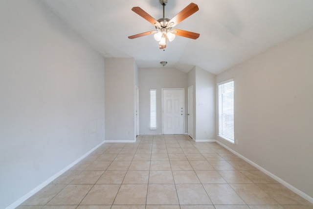 6635 Rusty Ridge Ln, Katy, TX 77449 - spare room with vaulted ceiling, ceiling fan, light tile patterned floors, and baseboards