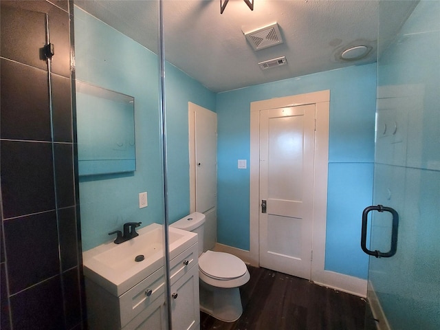 2906 Sledge St, Waller, TX 77484 - full bath with wood finished floors, vanity, toilet, and baseboards