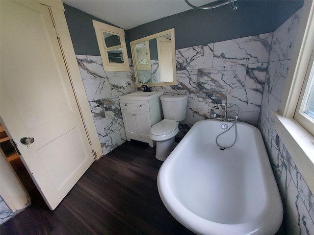 2906 Sledge St, Waller, TX 77484 - full bathroom with a bath, wood finished floors, tile walls, vanity, and toilet