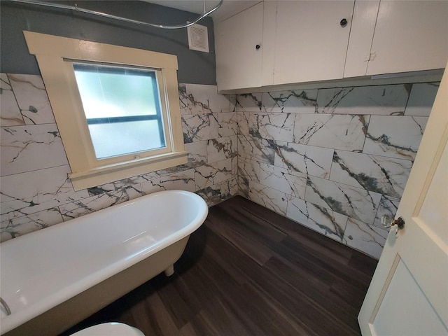 2906 Sledge St, Waller, TX 77484 - bathroom with a soaking tub, tile walls, and wood finished floors