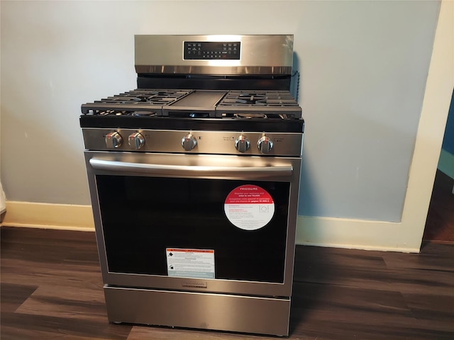 2906 Sledge St, Waller, TX 77484 - kitchen view of stainless steel gas range, dark wood finished floors, and baseboards