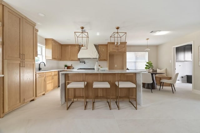2906 Riata Ln, Houston, TX 77043 - kitchen with a kitchen island, light countertops, a sink, custom exhaust hood, and hanging light fixtures