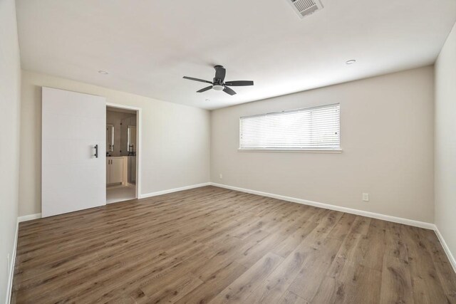 2906 Riata Ln, Houston, TX 77043 - empty room with light wood-type flooring, a ceiling fan, and baseboards