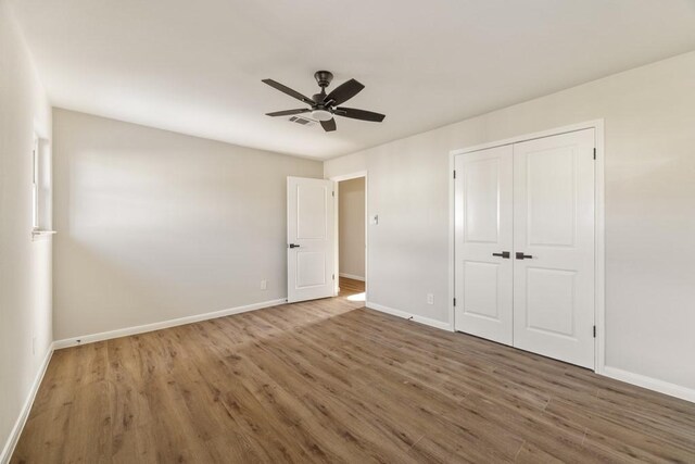 2906 Riata Ln, Houston, TX 77043 - unfurnished bedroom with wood finished floors and baseboards