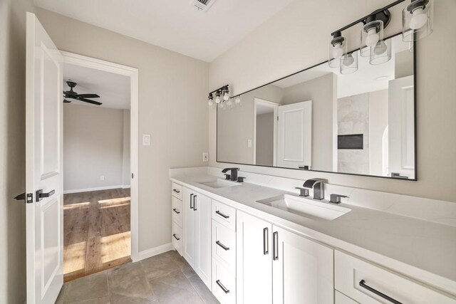 2906 Riata Ln, Houston, TX 77043 - full bath with double vanity, baseboards, and a ceiling fan