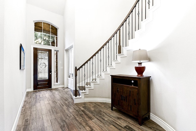 29306 Lovegrass Ct, Katy, TX 77494 - foyer entrance featuring wood finished floors, stairs, baseboards, and a towering ceiling