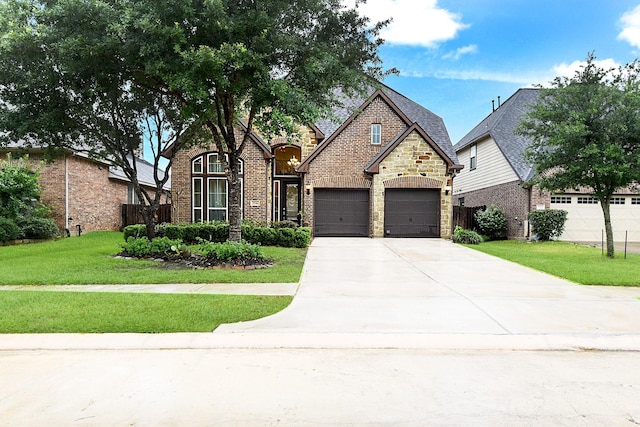 29306 Lovegrass Ct, Katy, TX 77494 - view of front facade with concrete driveway, stone siding, a garage, and brick siding