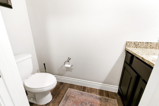 29306 Lovegrass Ct, Katy, TX 77494 - bathroom featuring vanity, wood finished floors, toilet, and baseboards