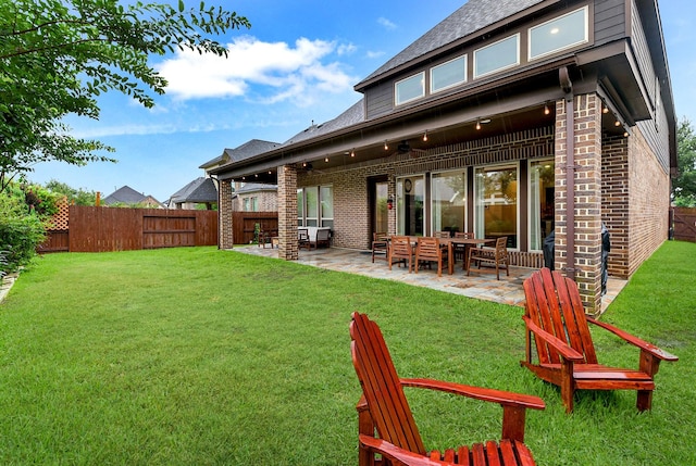 29306 Lovegrass Ct, Katy, TX 77494 - rear view of house with brick siding, a patio, and a shingled roof