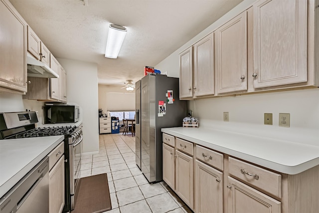 4934 Parkcrest Dr, La Porte, TX 77571 - kitchen with stainless steel appliances, light tile patterned floors, light countertops, ceiling fan, and under cabinet range hood
