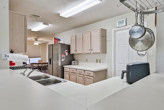 4934 Parkcrest Dr, La Porte, TX 77571 - kitchen with stainless steel refrigerator with ice dispenser, a sink, light brown cabinetry, a textured ceiling, and light countertops