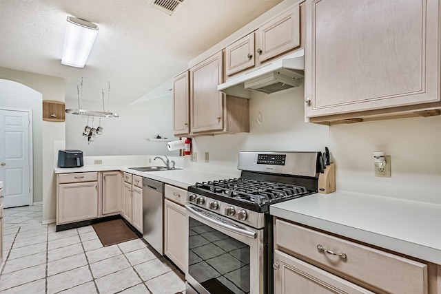 4934 Parkcrest Dr, La Porte, TX 77571 - kitchen featuring stainless steel appliances, under cabinet range hood, a sink, light countertops, and light tile patterned floors