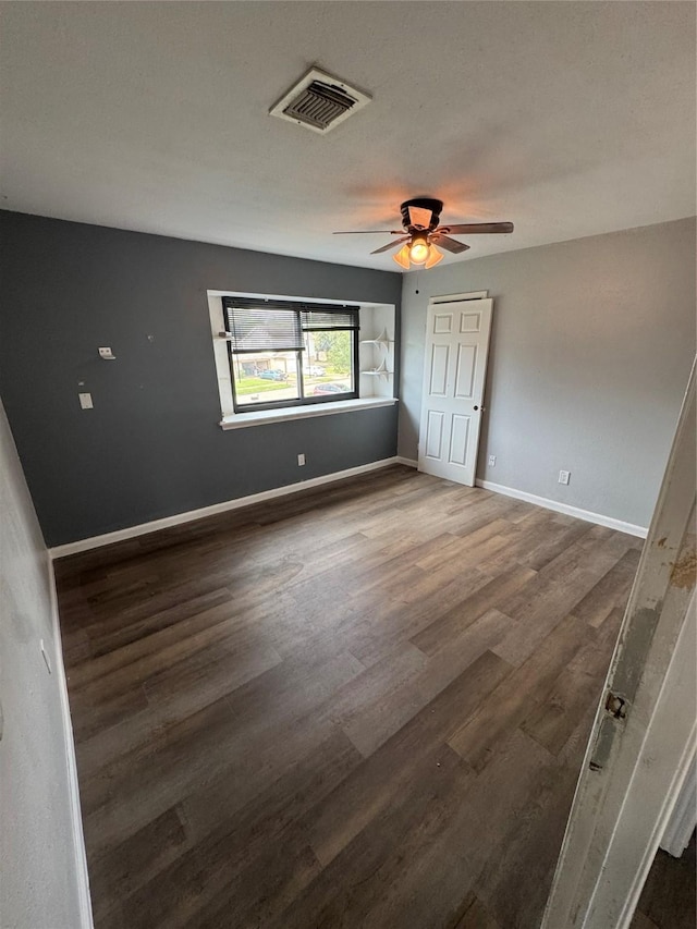 20806 Park Ridge Ct, Katy, TX 77450 - unfurnished bedroom with dark wood-style floors, baseboards, a ceiling fan, and a closet