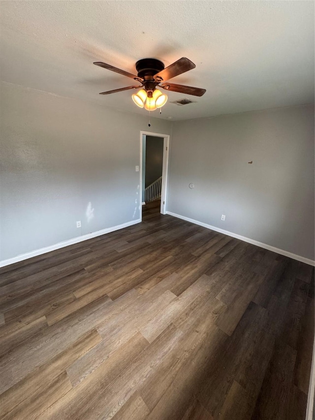 20806 Park Ridge Ct, Katy, TX 77450 - empty room with dark wood finished floors, ceiling fan, baseboards, and a textured ceiling