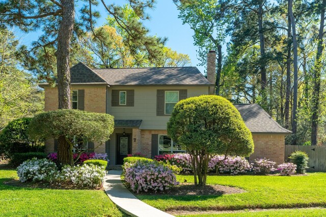 7 E Torch Pine Cir, The Woodlands, TX 77381 - view of front of property with brick siding, a chimney, and roof with shingles