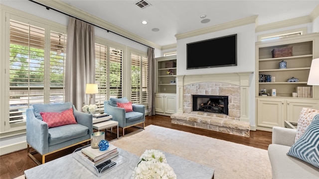 5558 Aspen St, Bellaire, TX 77401 - living room with ornamental molding, a fireplace, dark wood-type flooring, built in features, and recessed lighting