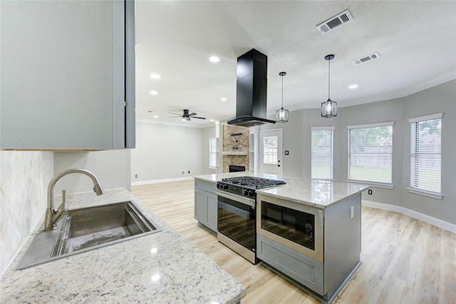 13727 Sablegarden Ln, Houston, TX 77014 - kitchen featuring island range hood, black appliances, a sink, ceiling fan, and ornamental molding