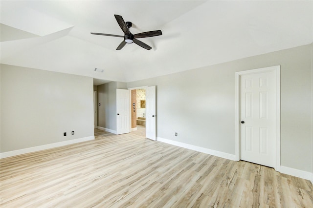 13727 Sablegarden Ln, Houston, TX 77014 - unfurnished bedroom with light wood-style flooring, baseboards, connected bathroom, lofted ceiling, and ceiling fan