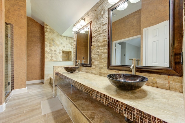 13727 Sablegarden Ln, Houston, TX 77014 - full bathroom with double vanity, vaulted ceiling, and wood finished floors