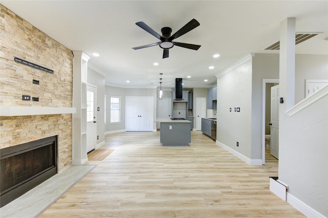 13727 Sablegarden Ln, Houston, TX 77014 - unfurnished living room with ornamental molding, a ceiling fan, baseboards, light wood-type flooring, and a fireplace