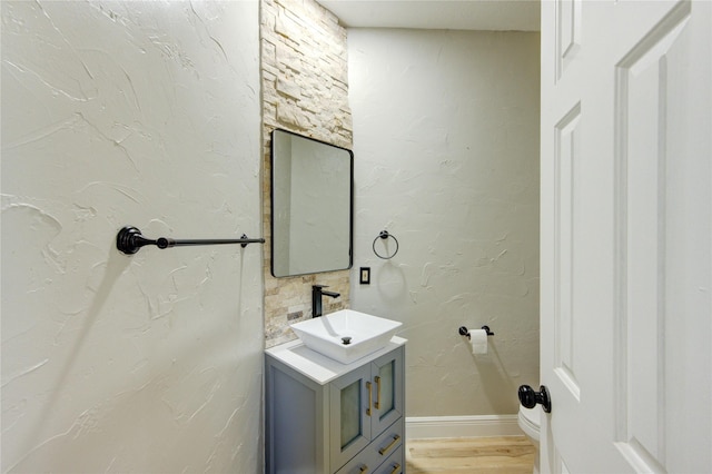 13727 Sablegarden Ln, Houston, TX 77014 - bathroom featuring vanity, wood finished floors, and baseboards