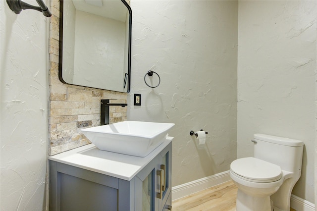 13727 Sablegarden Ln, Houston, TX 77014 - bathroom with vanity, wood finished floors, toilet, and baseboards