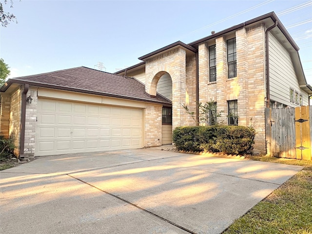 1935 Creekshire Dr, Sugar Land, TX 77478 - view of front of home with an attached garage, stone siding, concrete driveway, roof with shingles, and a gate